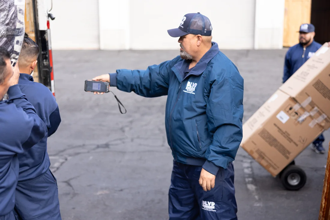 BLVD moving professional reviewing a digital inventory scanner