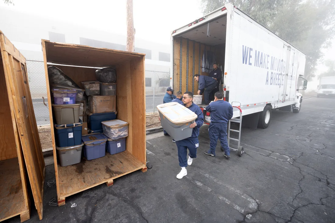 BLVD storage containers staged beside a moving truck